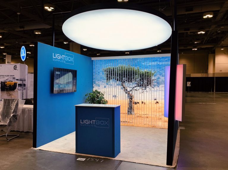 Small tradeshow booth made of LED lightboxes and a Lumi Ceiling lightbox