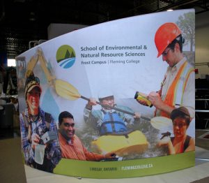 Custom shaped SOHO event background, features a graphic of various people in the school of environmental science.